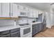 Modern kitchen featuring white cabinets, stainless appliances, subway tile backsplash, and grey base cabinets at 4344 W Kimberly Way, Glendale, AZ 85308