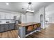 Bright kitchen with stainless steel appliances, granite countertops, and wood breakfast bar seating at 4344 W Kimberly Way, Glendale, AZ 85308