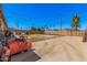 Large backyard area with an expansive patio, a block wall, and palm trees in the distance at 4403 N 48Th Dr, Phoenix, AZ 85031