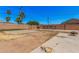 Fenced backyard with a large concrete patio, some grass, and scattered trees at 4403 N 48Th Dr, Phoenix, AZ 85031