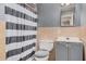 Bathroom featuring a striped shower curtain, a standard toilet, and a painted vanity at 4403 N 48Th Dr, Phoenix, AZ 85031