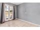 Bright bedroom features tile floors, a glass door, and neutral gray paint at 4403 N 48Th Dr, Phoenix, AZ 85031