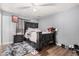 View of staged bedroom with dark furniture, accent rug, and ceiling fan at 4403 N 48Th Dr, Phoenix, AZ 85031