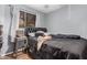 Bedroom with a black padded headboard, hardwood floors, and natural light from window at 4403 N 48Th Dr, Phoenix, AZ 85031