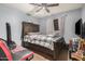 Cozy bedroom with wood floors, an overhead fan, and a large wood framed bed at 4403 N 48Th Dr, Phoenix, AZ 85031