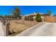 Street view of a single-story home with a stone accent facade and a mature tree at 4403 N 48Th Dr, Phoenix, AZ 85031