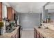 Kitchen view with appliances, dark wood cabinets, tile counter tops, and gray walls at 4403 N 48Th Dr, Phoenix, AZ 85031