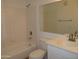 Bright bathroom featuring a shower-tub combo, vanity sink, and large mirror at 4465 E Paradise Village S Pkwy # 1200, Phoenix, AZ 85032