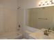 Bright bathroom featuring a shower-tub combo, vanity sink, and large mirror at 4465 E Paradise Village S Pkwy # 1200, Phoenix, AZ 85032