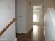 Upstairs hallway with neutral colors, tile floors, and doors leading to bedrooms or bathrooms at 4465 E Paradise Village S Pkwy # 1200, Phoenix, AZ 85032