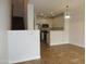 Open-concept living space with white walls, ceramic tile flooring, and a view to the modern kitchen at 4465 E Paradise Village S Pkwy # 1200, Phoenix, AZ 85032