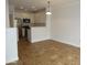 Open-concept living space with white walls, ceramic tile flooring, and a view to the modern kitchen at 4465 E Paradise Village S Pkwy # 1200, Phoenix, AZ 85032