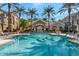 Community clubhouse featuring a large pool and lounge area with seating and mature palm trees at 4465 E Paradise Village S Pkwy # 1200, Phoenix, AZ 85032