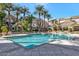 Community clubhouse featuring a large pool and lounge area with seating and mature palm trees at 4465 E Paradise Village S Pkwy # 1200, Phoenix, AZ 85032