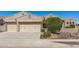 Charming home featuring a three car garage with neutral toned doors and desert landscaping in the front yard at 5107 N 194Th Dr, Litchfield Park, AZ 85340