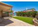 Backyard featuring an awning, turf, colorful bougainvillea, desert landscaping, and storage shed at 6035 N 9Th Ave, Phoenix, AZ 85013