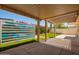 Backyard patio with an awning, artificial turf, colorful bougainvillea, and desert landscaping at 6035 N 9Th Ave, Phoenix, AZ 85013