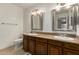 Bathroom with double sinks, granite countertops, and decorative mirrors at 6035 N 9Th Ave, Phoenix, AZ 85013