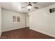 Bedroom featuring wood floors, neutral walls, ceiling fan and a window with shutters at 6035 N 9Th Ave, Phoenix, AZ 85013