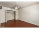 Bedroom featuring wood floors, ceiling fan, and a closet with bi-fold doors at 6035 N 9Th Ave, Phoenix, AZ 85013