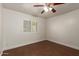 Bedroom featuring wood floors, neutral walls, ceiling fan and window with shutters at 6035 N 9Th Ave, Phoenix, AZ 85013