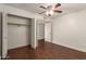 Bedroom showcasing wood floors, ceiling fan, and an open closet with bi-fold doors at 6035 N 9Th Ave, Phoenix, AZ 85013