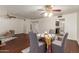 Dining room area featuring beautiful hardwood floors, a stylish ceiling fan, and neutral decor at 6035 N 9Th Ave, Phoenix, AZ 85013