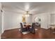 Dining room area with hardwood floors, comfortable seating, and a view into the living room at 6035 N 9Th Ave, Phoenix, AZ 85013