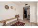 Hallway featuring a rustic bench with decorative pillows and a view into the kitchen at 6035 N 9Th Ave, Phoenix, AZ 85013