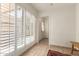 Bright hallway with shuttered windows and tiled floor leads to the front door at 6035 N 9Th Ave, Phoenix, AZ 85013