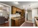Functional kitchen with tiled floor, granite countertops, dark wood cabinets, and modern appliances at 6035 N 9Th Ave, Phoenix, AZ 85013