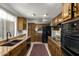 Well-equipped kitchen featuring granite countertops, dark cabinets, and black appliances at 6035 N 9Th Ave, Phoenix, AZ 85013
