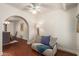Bright living room featuring hardwood floors, a light neutral sofa, and an arched doorway to the dining room at 6035 N 9Th Ave, Phoenix, AZ 85013