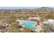 Aerial view showcasing the community pool area surrounded by desert landscape and scenic mountain views at 7283 E Brisa Dr, Scottsdale, AZ 85266