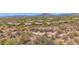 Expansive aerial view showcasing the community's desert landscape, mountain views, and well-maintained homes at 7283 E Brisa Dr, Scottsdale, AZ 85266
