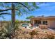 Wide backyard shot of pool, lounge chairs, outdoor kitchen, desert landscaping, and the home at 7283 E Brisa Dr, Scottsdale, AZ 85266