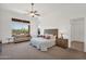Bright bedroom featuring a ceiling fan, carpeted floors, view of mountains and a comfortable sitting area at 7283 E Brisa Dr, Scottsdale, AZ 85266