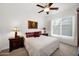 Inviting bedroom featuring a ceiling fan, carpeted floors, side tables with lamps, and a comfortable bed at 7283 E Brisa Dr, Scottsdale, AZ 85266