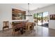 Dining area with a wooden table, sliding glass doors to the patio, and a decorative light fixture at 7283 E Brisa Dr, Scottsdale, AZ 85266
