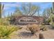 Beautiful stone sign welcomes you to Bellasera, surrounded by lush desert landscaping and sunny blue skies at 7283 E Brisa Dr, Scottsdale, AZ 85266