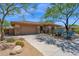 Front view of a single-story home with a desert landscaped yard and a spacious three-car garage at 7283 E Brisa Dr, Scottsdale, AZ 85266
