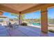 Back patio with lounge chairs, outdoor kitchen, outdoor furniture, and desert views at 7283 E Brisa Dr, Scottsdale, AZ 85266