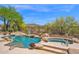 Backyard pool and hot tub with desert landscaping and a black metal fence surrounding the yard at 7283 E Brisa Dr, Scottsdale, AZ 85266