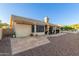 Paver patio with stucco walls overlooks a landscaped backyard with mature trees at 8061 E Lavender Dr, Gold Canyon, AZ 85118