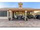 Spacious covered backyard patio with plenty of room for entertaining, and a decorative sunflower chimney at 8061 E Lavender Dr, Gold Canyon, AZ 85118
