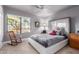 Bright bedroom with modern furnishings, neutral walls, a rocking chair, and a large window at 8061 E Lavender Dr, Gold Canyon, AZ 85118