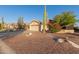 Desert landscaping compliments this charming single-story home with a wide driveway and two-car garage at 8061 E Lavender Dr, Gold Canyon, AZ 85118
