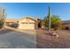 Charming single-Gathering home featuring a two-car garage, desert landscaping, and mature Saguaro cactus at 8061 E Lavender Dr, Gold Canyon, AZ 85118