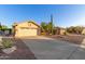 Charming single-story home featuring a desert landscape, wide driveway, and a two-car garage at 8061 E Lavender Dr, Gold Canyon, AZ 85118