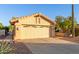 Garage of a single-story home featuring desert landscaping, and a wide driveway at 8061 E Lavender Dr, Gold Canyon, AZ 85118
